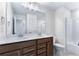 Double vanity bathroom with dark brown cabinets and a shower/tub combo at 6019 Wheeler Ridge Rd, Auburn, GA 30011