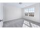 Well-lit bedroom featuring a large window and carpet flooring at 6019 Wheeler Ridge Rd, Auburn, GA 30011