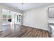 Bright dining room with hardwood floors and a view into the sunroom at 6019 Wheeler Ridge Rd, Auburn, GA 30011
