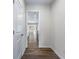 Bright hallway with wood-look floors leading to the kitchen and living areas at 6019 Wheeler Ridge Rd, Auburn, GA 30011