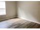 Simple bedroom with wood-look floors and a window at 6190 Tucker Ln, Union City, GA 30291