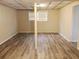 Finished basement area with window and wood-look floors at 6190 Tucker Ln, Union City, GA 30291