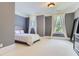 Spacious bedroom with gray walls, white bedding, and ample natural light at 9620 Cedar Grove Rd, Chattahoochee Hills, GA 30213