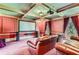 Elegant home theater with large projection screen, leather seating, and rich color palette at 9620 Cedar Grove Rd, Chattahoochee Hills, GA 30213