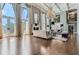Spacious living room with hardwood floors, large windows, and a stunning chandelier at 9620 Cedar Grove Rd, Chattahoochee Hills, GA 30213