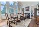 Elegant dining room featuring hardwood floors, a fireplace, and large windows at 9620 Cedar Grove Rd, Chattahoochee Hills, GA 30213
