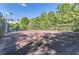 Private tennis court nestled in a wooded area at 9620 Cedar Grove Rd, Chattahoochee Hills, GA 30213