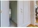 View of a hallway with access to another room and utility closet at 9620 Cedar Grove Rd, Chattahoochee Hills, GA 30213