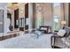Bright and airy living room with large windows and a stunning chandelier at 9620 Cedar Grove Rd, Chattahoochee Hills, GA 30213