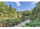 Elevated view of a private tennis court nestled in the woods at 9620 Cedar Grove Rd, Chattahoochee Hills, GA 30213