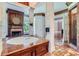 Luxurious bathroom with marble flooring, a large tub, and a fireplace at 9620 Cedar Grove Rd, Chattahoochee Hills, GA 30213
