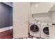 Bright laundry room with washer, dryer, and ample cabinet space at 9620 Cedar Grove Rd, Chattahoochee Hills, GA 30213