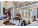 Elegant living room with double-height ceilings, spiral staircase, and grand piano at 9620 Cedar Grove Rd, Chattahoochee Hills, GA 30213