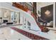 Grand entryway showcasing a curved staircase and marble flooring at 9620 Cedar Grove Rd, Chattahoochee Hills, GA 30213
