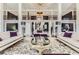 Elegant living room with high ceilings, a large chandelier, and stunning views at 9620 Cedar Grove Rd, Chattahoochee Hills, GA 30213