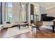 Elegant living room with hardwood floors, curved sofa, and grand piano at 9620 Cedar Grove Rd, Chattahoochee Hills, GA 30213