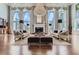 Bright living room with hardwood floors, fireplace and floor to ceiling windows at 9620 Cedar Grove Rd, Chattahoochee Hills, GA 30213