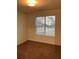 Bright bedroom with carpet flooring and a large window at 1051 Foxchase Dr, Mcdonough, GA 30253