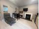 Living room with a chaise lounge, electric fireplace, and TV at 1323 Briarcliff Ne Rd, Atlanta, GA 30306