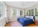 Comfortable bedroom featuring hardwood floors and large windows at 1323 Briarcliff Ne Rd, Atlanta, GA 30306