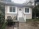 Cute cottage with rocking chairs and a small table on the front porch at 1323 Briarcliff Ne Rd, Atlanta, GA 30306