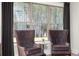 Relaxing sitting area with two armchairs and a window overlooking the backyard at 3749 Tielman St, Snellville, GA 30078