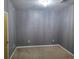 Empty bedroom with gray walls, carpeted floor, and a chandelier at 898 Oak Sw St # 3108, Atlanta, GA 30310