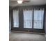 Bright bedroom with three windows, neutral walls, and carpet flooring at 898 Oak Sw St # 3108, Atlanta, GA 30310
