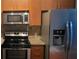 Modern kitchen with stainless steel microwave, stove, and refrigerator at 898 Oak Sw St # 3108, Atlanta, GA 30310