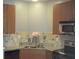 Kitchen with wood cabinets, granite countertops, and tile backsplash at 898 Oak Sw St # 3108, Atlanta, GA 30310