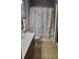 Bathroom with shower/tub combo, white vanity, and seashell-themed decor at 898 Oak Sw St # 3108, Atlanta, GA 30310