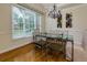 Formal dining room with glass-top table and hardwood floors at 3204 Creek W Trce, Powder Springs, GA 30127