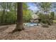 In-ground pool with safety cover, surrounded by trees and landscaping at 178 Seals Dr, Dallas, GA 30157