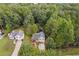 Aerial view of a house nestled in a wooded area, showcasing a tranquil setting at 178 Seals Dr, Dallas, GA 30157
