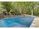 Inviting in-ground pool with a safety cover, nestled in a wooded backyard at 178 Seals Dr, Dallas, GA 30157