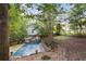 House with in-ground pool and safety cover in wooded backyard at 178 Seals Dr, Dallas, GA 30157