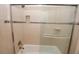 Updated bathroom with beige tile, a glass shower door, and a built-in shelf at 3021 Margaret Mitchell Dr # 8, Atlanta, GA 30327