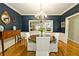 Bright dining room with a dark blue accent wall and a wooden table at 3021 Margaret Mitchell Dr # 8, Atlanta, GA 30327