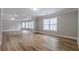 Ample bedroom with wood-look floors and large windows at 351 Chandler Bluff Ct, Grayson, GA 30017