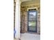 Brick front entry with a dark-bronze door and a wooden welcome sign at 222 Gallant Fox Way, Acworth, GA 30102