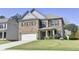 Two-story home with brick front and attached garage at 222 Gallant Fox Way, Acworth, GA 30102