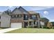 Two-story brick house with landscaped yard at 222 Gallant Fox Way, Acworth, GA 30102