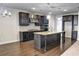 Modern kitchen with dark cabinets, granite countertops, and stainless steel appliances at 222 Gallant Fox Way, Acworth, GA 30102