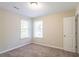 Bright bedroom with carpet flooring and two windows at 280 Green Commons Dr, Covington, GA 30016