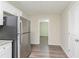 Kitchen with stainless steel refrigerator and view into adjacent living area at 280 Green Commons Dr, Covington, GA 30016