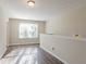 Living room with large window and wood-look flooring at 280 Green Commons Dr, Covington, GA 30016