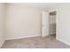 Simple bedroom with carpet flooring and an open door at 280 Green Commons Dr, Covington, GA 30016