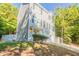 Two-story gray sided home with a two-car garage and wooded lot at 280 Green Commons Dr, Covington, GA 30016