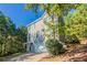Two-story gray sided home with a two-car garage and wooded lot at 280 Green Commons Dr, Covington, GA 30016