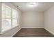 Bright bedroom with large window and wood-look flooring at 280 Green Commons Dr, Covington, GA 30016